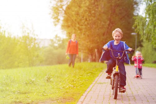 Kid enjoying outdoor activities, like riding a bike
