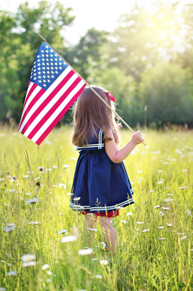 Girl holding American Flag Memorial Day