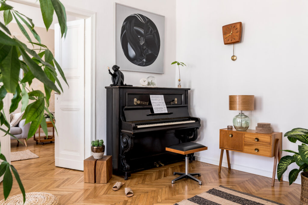 Room with vintage black piano and other vintage furniture and unique art pieces. Followtheflow© Shutterstock