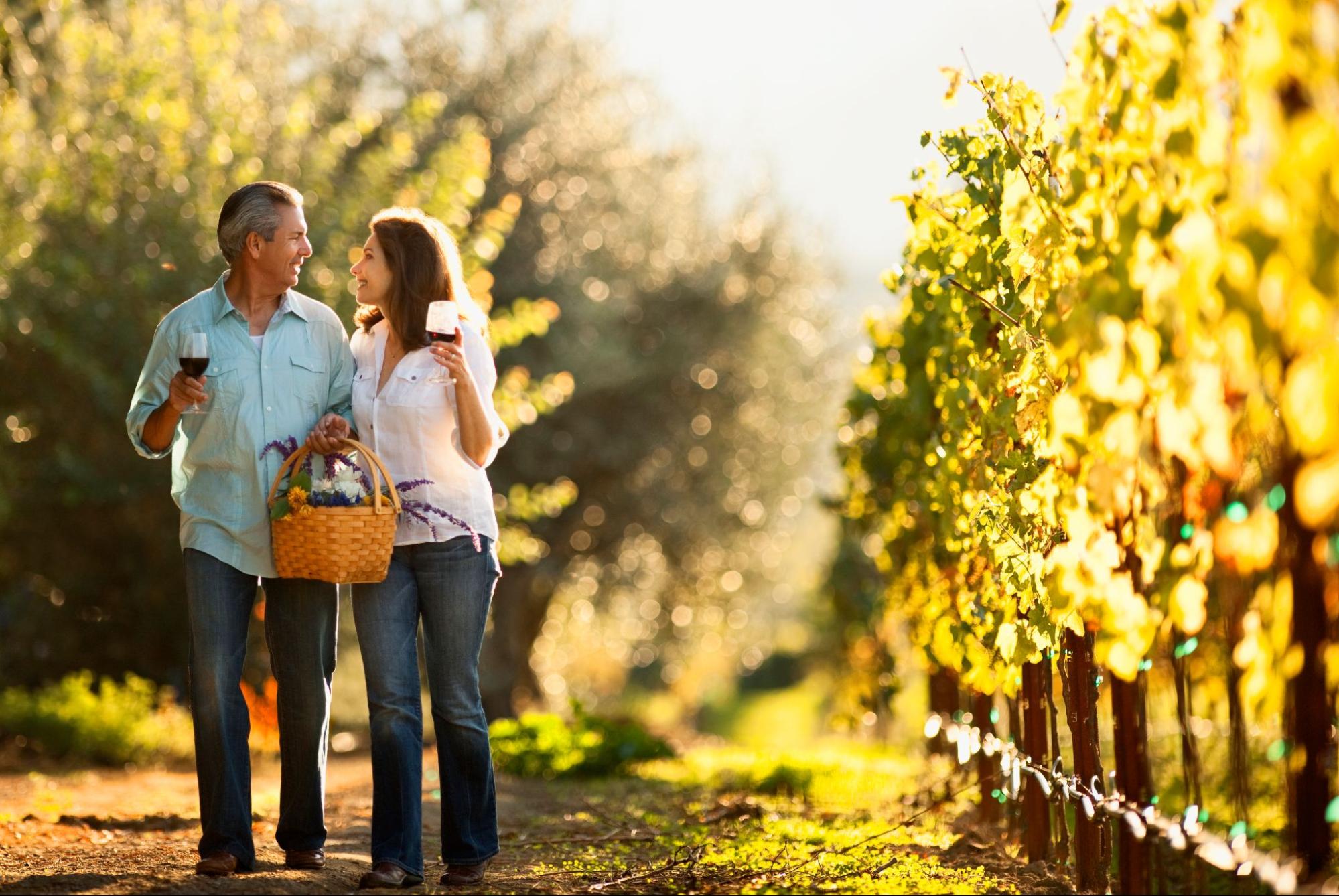 Couple walking through vineyard on a romantic weekend getaway ©Erickson Stock