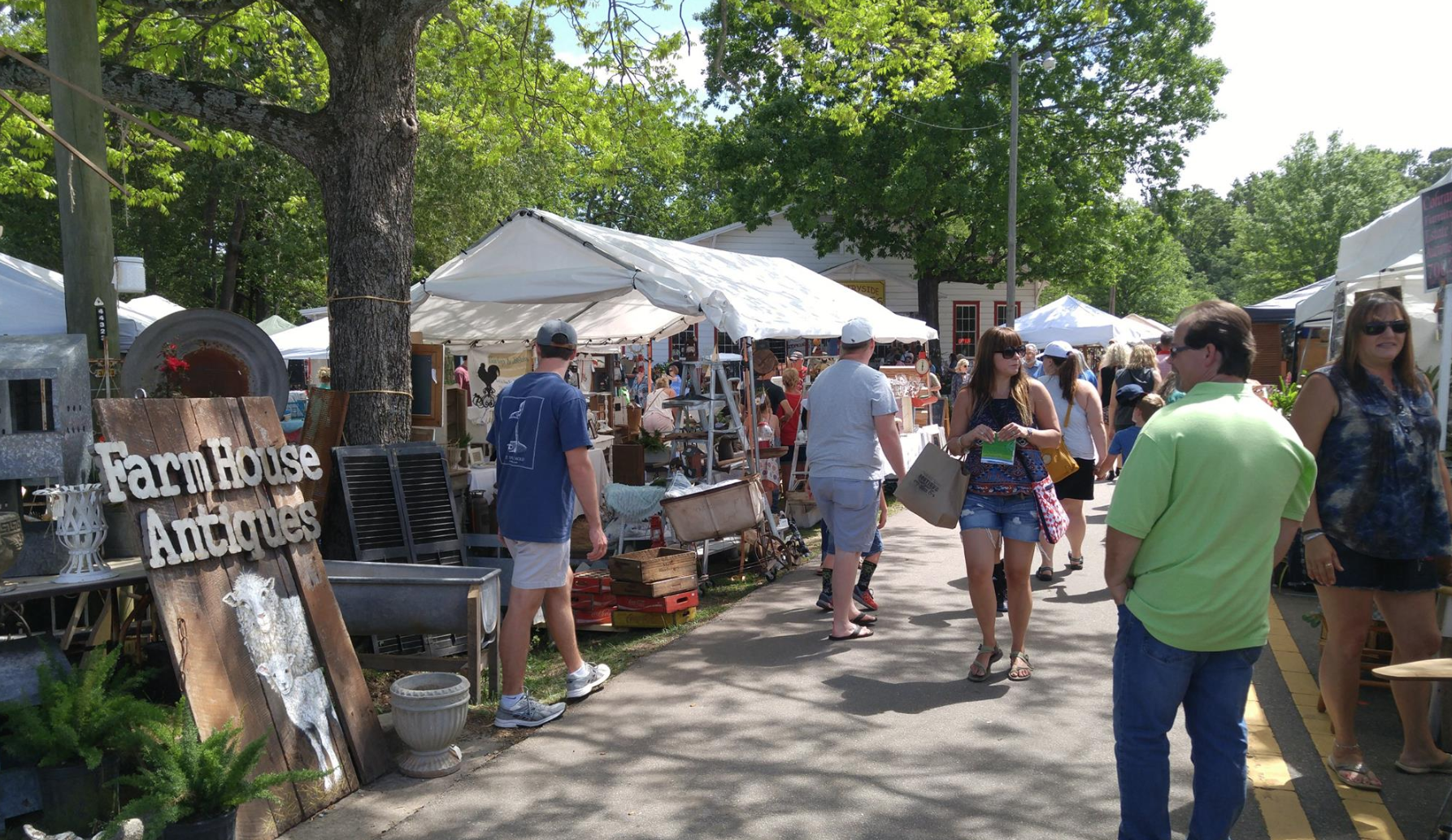 people walking through a farmers market